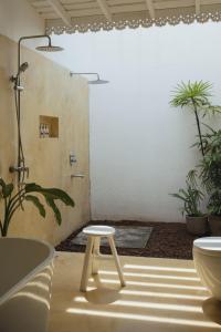 La salle de bains est pourvue d'une douche et d'un tabouret. dans l'établissement Merchant House, à Ahangama