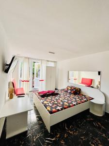 a bedroom with a bed and a desk and a window at Lemberg Relax House in Lviv