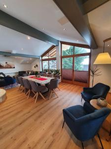 a large living room with a table and chairs at Premium Mara in Sankt Johann im Pongau
