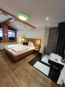 a bedroom with a large bed and a sink at Premium Mara in Sankt Johann im Pongau