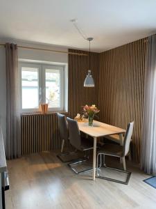 a dining room with a wooden table and chairs at Ferienhaus Butterfly in Garmisch-Partenkirchen
