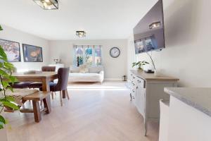 a kitchen and living room with a table and a dining room at Magnolia House in Leamington Spa