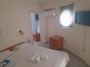 Un ou plusieurs lits dans un hébergement de l'établissement San Remo Hotel