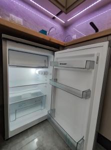 un réfrigérateur vide avec une porte ouverte dans une pièce dans l'établissement MODIANO CENTRAL STUDIO, à Thessalonique