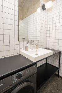 a bathroom with a sink and a washing machine at Bright Apartment in Vinohrady by Prague Days in Prague