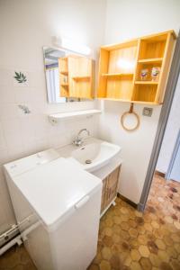 a bathroom with a toilet and a sink at Les Campanules in Saint-Léger-les-Mélèzes