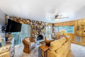 a living room with a couch and a tv at Sun Valley Hideaway in Ketchum
