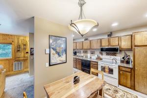 a kitchen with wooden cabinets and a wooden table at Sun Valley Hideaway in Ketchum