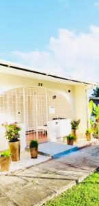 a house with potted plants in front of it at SugaLove Villa 30 Flamboyant Ave in Saint James