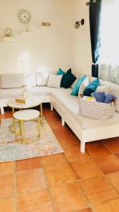 a living room with a white couch and a table at SugaLove Villa 30 Flamboyant Ave in Saint James