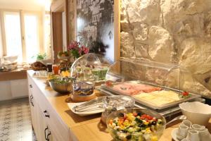 a kitchen counter with a bunch of food on it at Hotel At the Green Grape in Prague