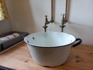 a white bath tub with two water faucets on top at DeKotzenhof in Wakkerstroom