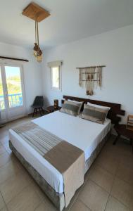a bedroom with a large bed in a room at Sarakiniko Rooms in Adamantas