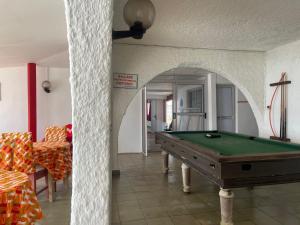 a pool table in the middle of a room at Hotel La Madrague in Grand-Bassam