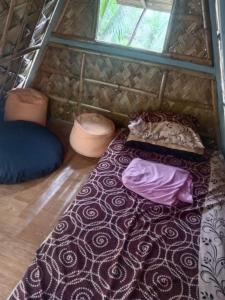 a room with a mattress and pillows on a floor at Camp Mayagay Tanay Rizal in Sampalok