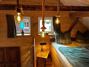 1 dormitorio en una cabaña de madera con cama y luces en Ferienwohnung Griaß Di, en Burgberg