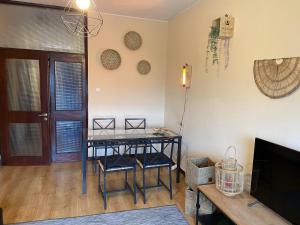 a living room with a table and a tv at Spacious apartment with parking at Serralves in Porto