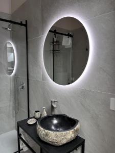 a bathroom with a large sink and a mirror at Fiera Milano City Apartment in Milan