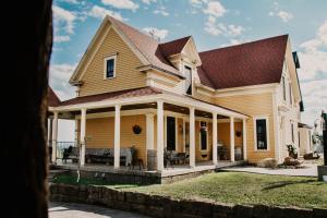 a large yellow house with a roof at Magnetic Hill Winery in Moncton