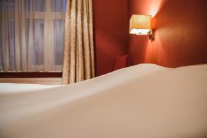 Postel nebo postele na pokoji v ubytování Hotel Louisa