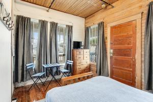 a bedroom with a bed and two chairs and a window at Lucky Number #13 in Tybee Island