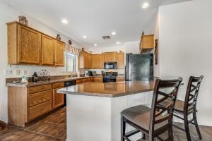 a kitchen with wooden cabinets and a counter top at Honeysuckle Hideaway in Gold Canyon