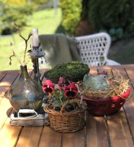 a table topped with a basket of flowers and a candle at Willa Urocze in Muszyna