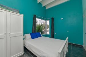 a blue bedroom with a bed and a window at A Serene Retreat with Modern Amenities in Santa Cruz
