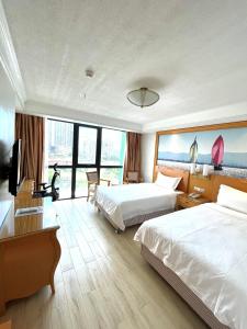Postel nebo postele na pokoji v ubytování ROYAL J HOTEL