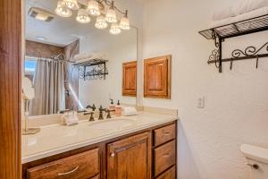 a bathroom with a sink and a mirror at Sunrise Vista Villa in Angel Fire +28 photos