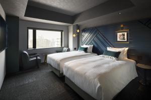 Un pat sau paturi într-o cameră la Mercure Tokyu Stay Osaka Namba