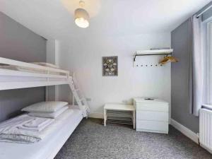 a bedroom with a bunk bed and a desk at West Lodge, Filey. Sleeps 8, 7 mins walk to beach in Filey