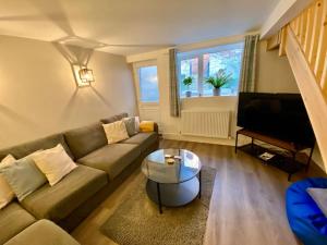 a living room with a couch and a coffee table at West Lodge, Filey. Sleeps 8, 7 mins walk to beach in Filey