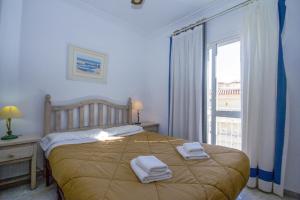 A bed or beds in a room at Canovas Nerja - Casa adosada con piscina Los Huertos 7