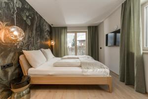 a bedroom with a bed and a tv on a wall at CHILL HOUSE in Schladming