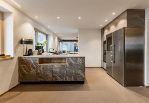 a kitchen with a stainless steel refrigerator at CHILL HOUSE in Schladming