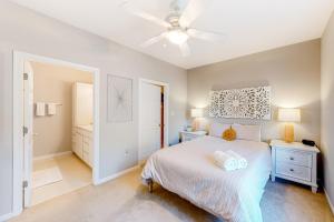 a bedroom with a bed and a ceiling fan at Creekwood --- 100 Cascade Ln, #109 in Rehoboth Beach