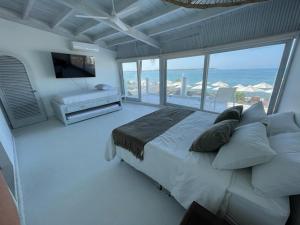 a bedroom with a bed with a view of the ocean at Wala beach club in Cartagena de Indias