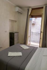 a bedroom with a large bed and a window at Casa vacanza russo enzo in Naples