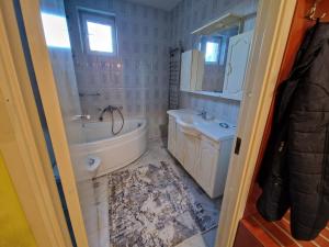 a bathroom with a sink and a tub and a toilet at Avalon Apartments in Belgrade +24 photos