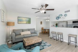 a living room with a couch and a table at 261 G Madeira Beach Yacht Club in St. Pete Beach