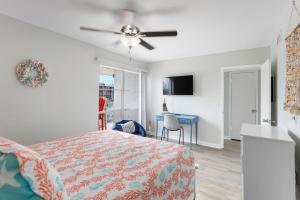 a bedroom with a bed and a ceiling fan at 261 G Madeira Beach Yacht Club in St Pete Beach