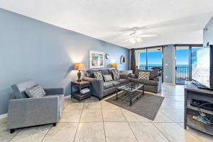 a living room with a couch and chairs and a tv at Phoenix V 202 in Orange Beach