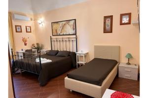 a bedroom with a bed and a bed and a couch at Airport Rooms - Bari in Bari