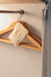 a wooden hanger with a sign on it at Paros Comfy Suites in Naousa