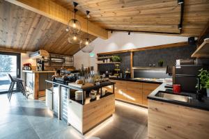 a large kitchen with wooden ceilings and wooden counters at Aparthotel Fuxbau in Flachau