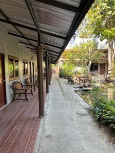 an outdoor patio with benches and a pond at Chiang Khan Hill Resort in Chiang Khan