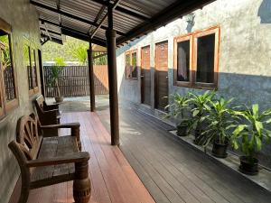 a porch with benches and plants on a house at Chiang Khan Hill Resort in Chiang Khan