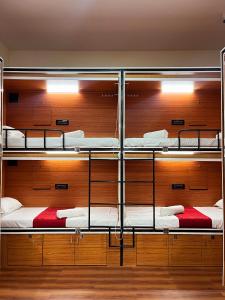 a room with three bunk beds with wooden walls at Rahul Men's AC Dormitory in Navi Mumbai