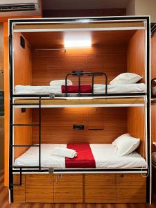 a room with three bunk beds in a room at Rahul Men's AC Dormitory in Navi Mumbai